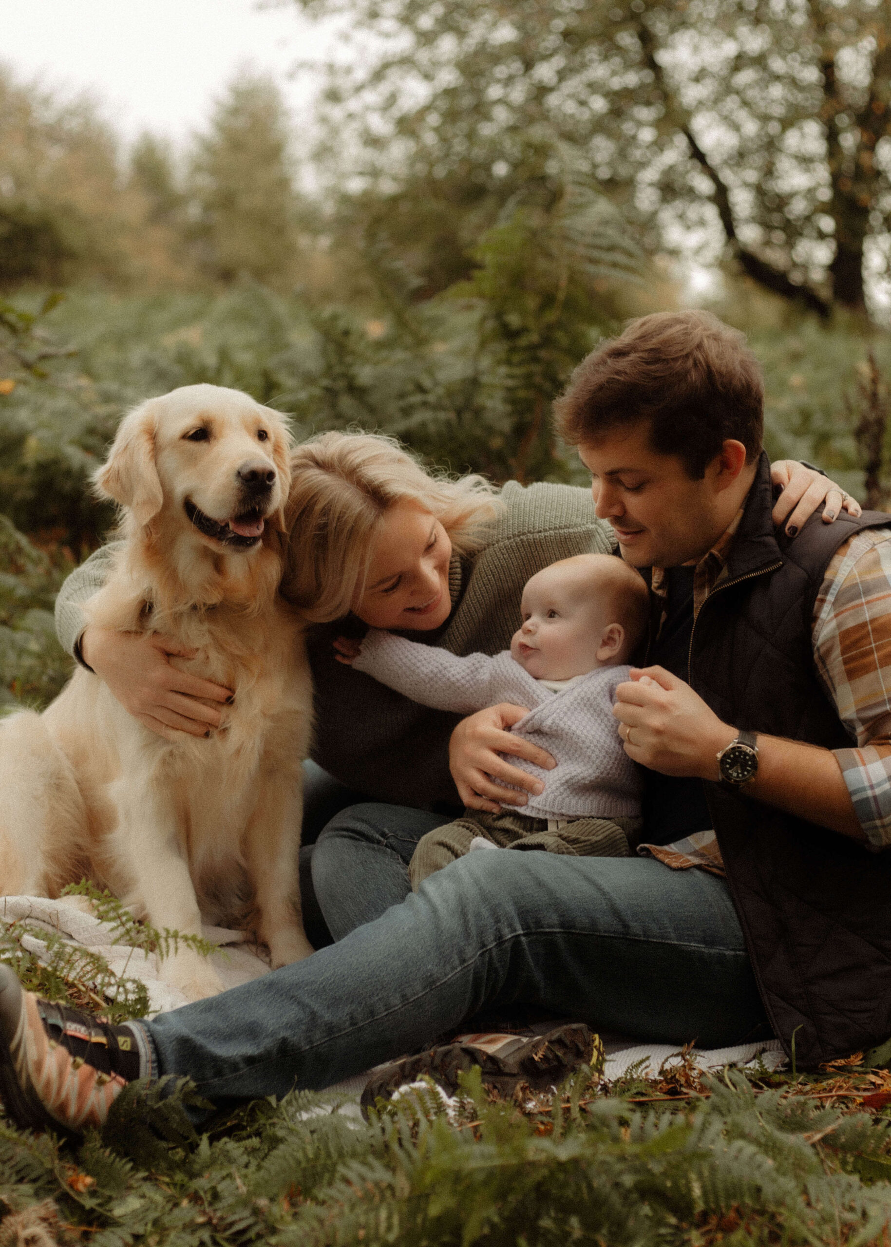young family, with dog, posing for a family photoshoot in Oxfordshire